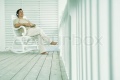 1509115-15390-odilon-dimier-altopress-maxppp-man-sitting-in-rocking-chair-on-porch-listening-to-headphones.jpg